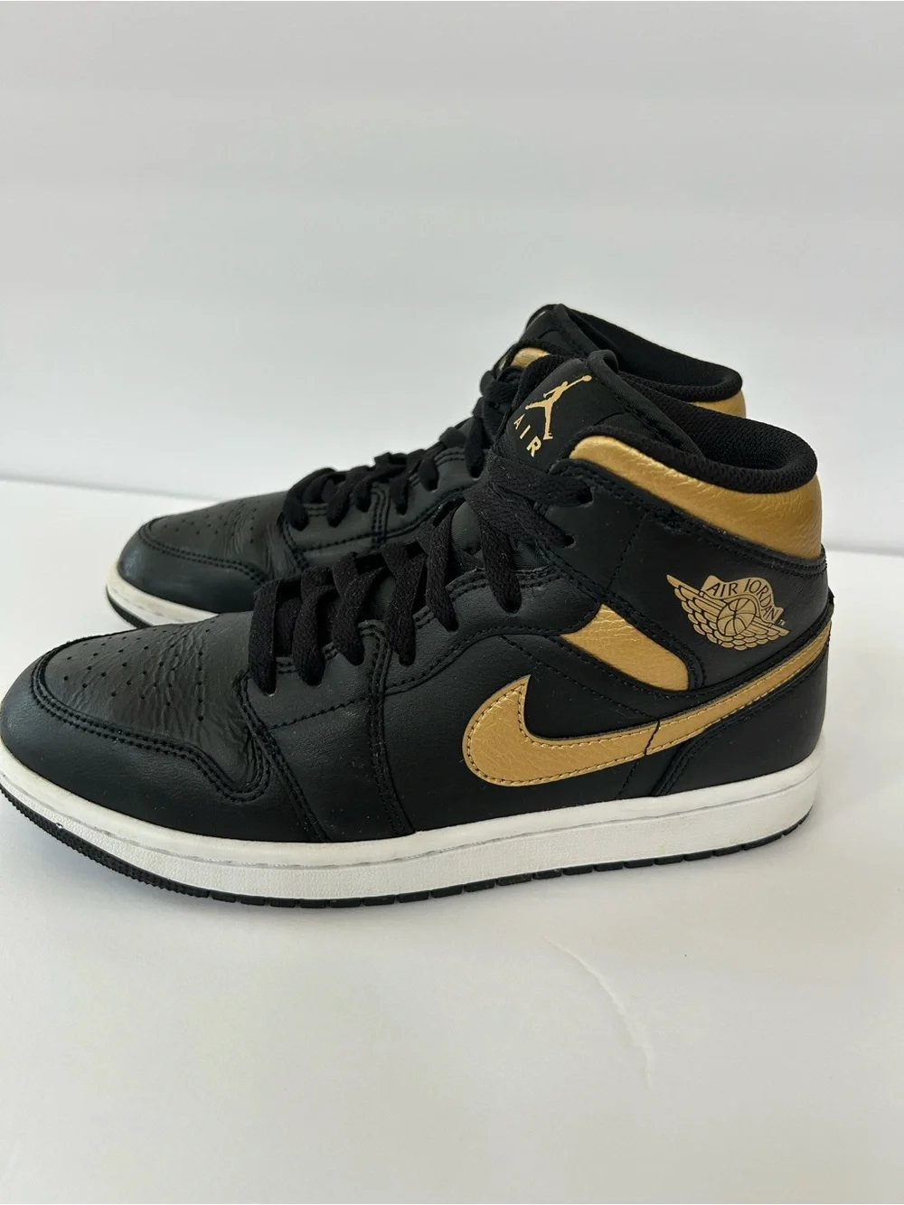 Air Jordan Black and Gold High-Top Sneakers